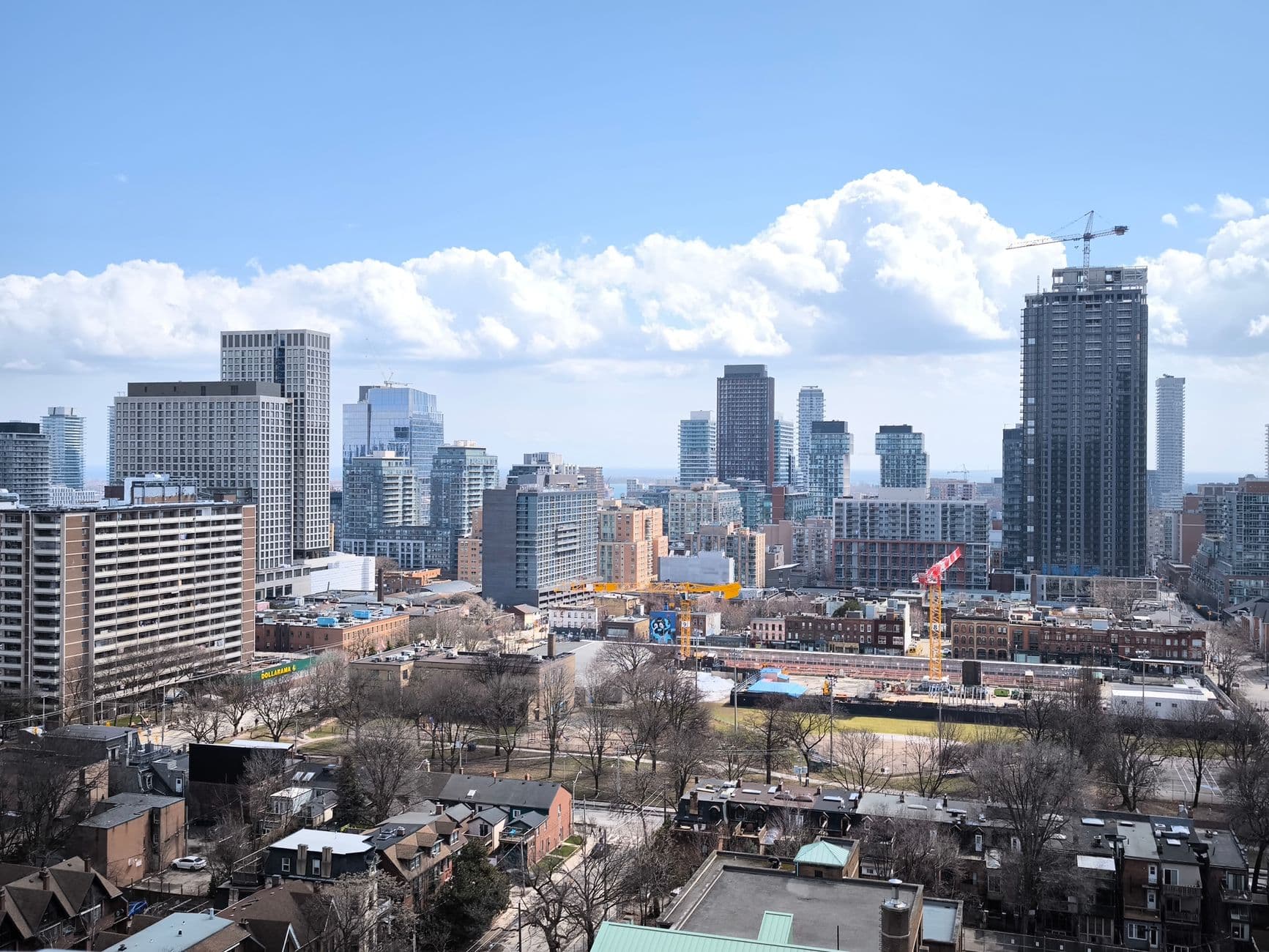 View of Toronto skyline showcasing modern skyscrapers and urban development under clear skies.